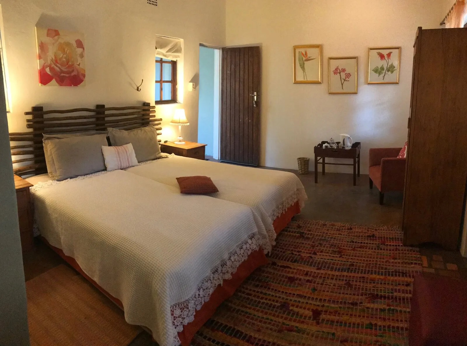 Kaia room with queen bed, botanical art, and tea station